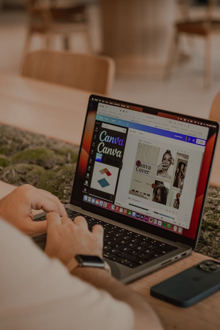 why-choose-us Close-up of a person using a laptop to design with Canva.