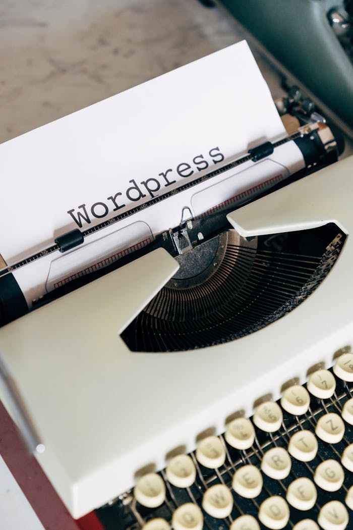 hero-img-01 Close-up of a vintage typewriter with 'Wordpress' typed on paper, conveying a classic theme.