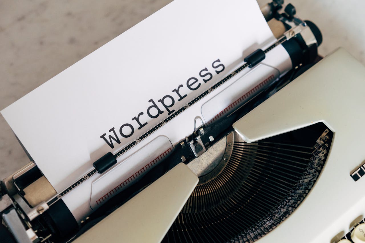 hero-img-02 Close-up of a vintage typewriter with a paper displaying 'WordPress', ideal for blogging and writing concepts.